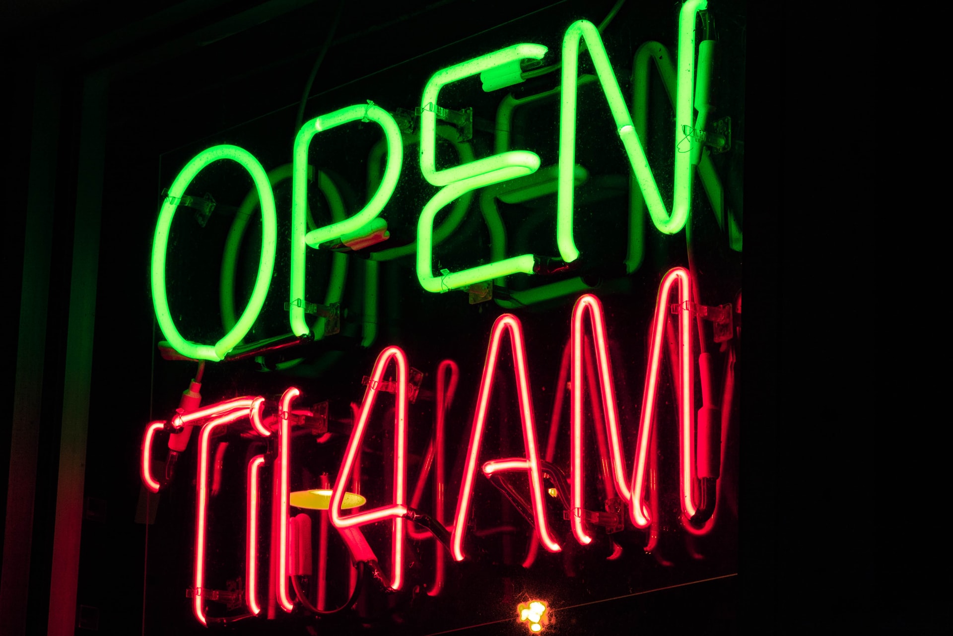 Neon Green and Red Open sign Roaring Twenties Photo by Mitchell Griest on Unsplash