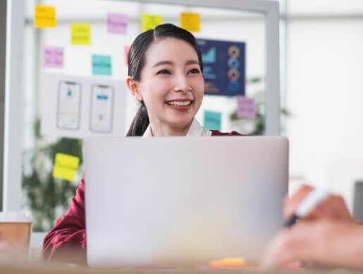 Female Web Developer Smiling At Work On Laptop Tech Job Interview